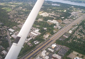 Flying over Factoria, looking roughly northeast. I-90 is below with Lake Sammamish visible on the top-right corner.